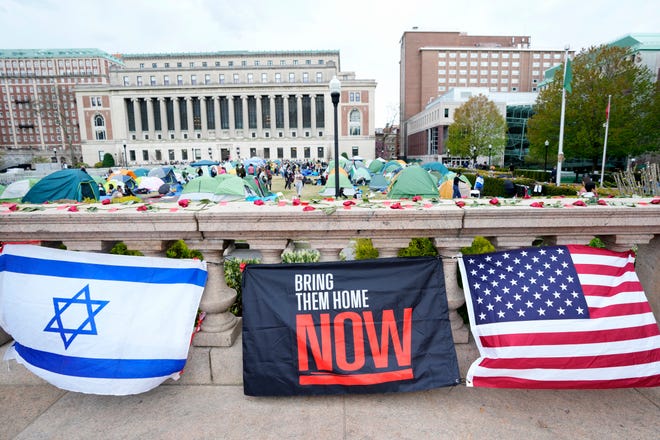 An Israeli flag is shown near an American flag, outside the encampment on the Columbia University campus on April 24, 2024, in New York City. Protesters at Columbia University faced a deadline to dismantle their encampment by April 26, as protests and arrests intensified across the nation.