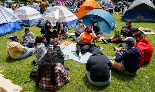 A study group meets on April 25, 2024 in an encampment that UCLA students setup on campus to show support for Palestinians in the Gaza conflict.
