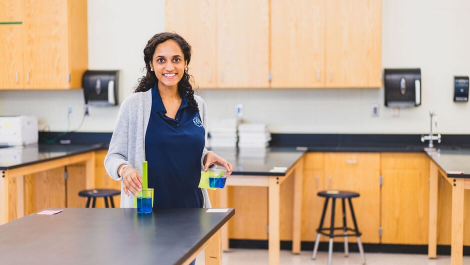 teacher in classroom smiling