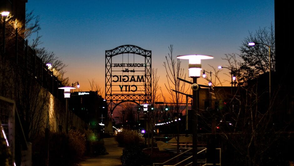 a sign reads magic city at sunset
