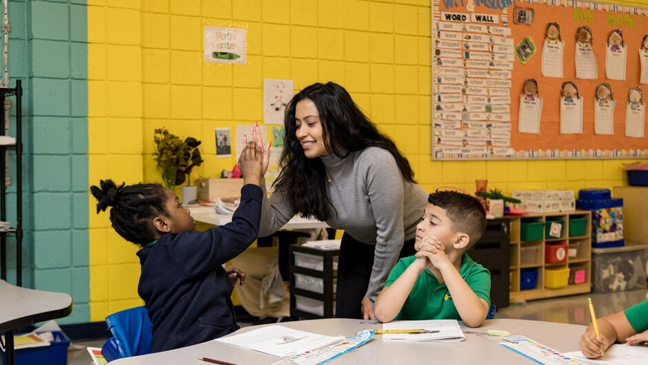 Teacher high fiving student